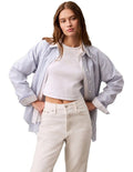 Calvin Klein Jeans white monogram baby tee with slim fit, cropped length, ribbed cotton stretch fabric, short sleeves and crew neck
