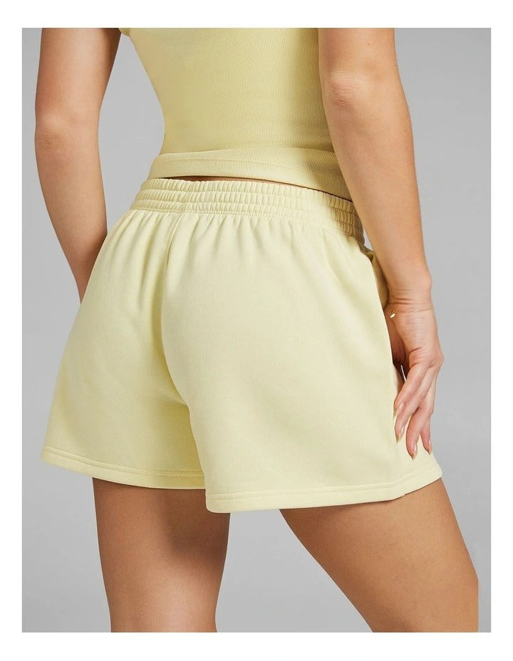 Rockwear women’s yellow cosy fleece shorts with relaxed fit, regular rise, and side phone pockets, perfect for lounging or casual wear.