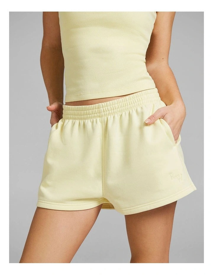 Rockwear women’s yellow cosy fleece shorts with relaxed fit, regular rise, and side phone pockets, perfect for lounging or casual wear.