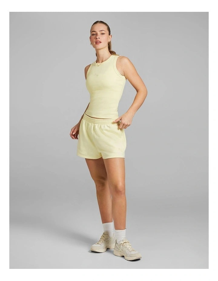 Rockwear women’s yellow cosy fleece shorts with relaxed fit, regular rise, and side phone pockets, perfect for lounging or casual wear.