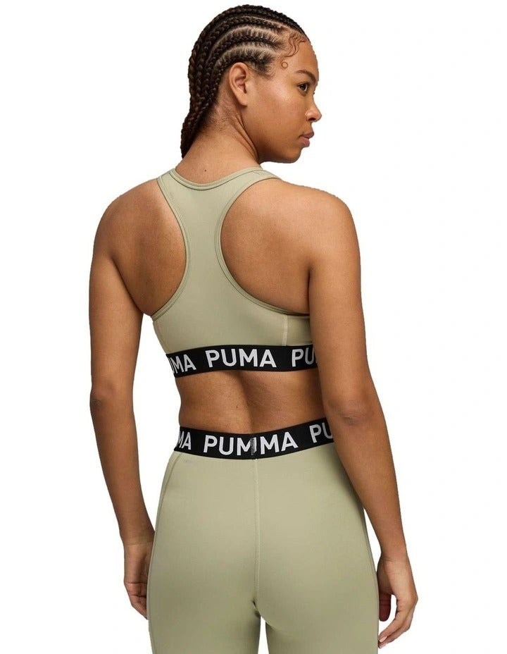 Woman wearing Puma athletic wear on a white background