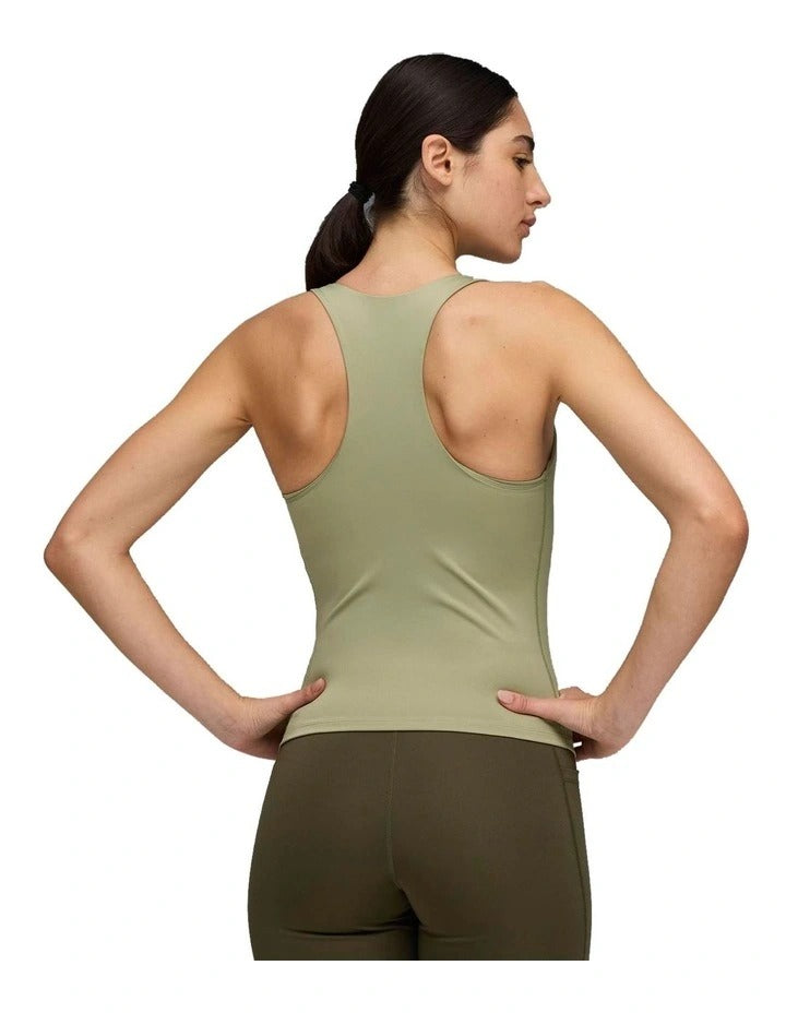 Woman wearing a green tank top with a brand logo on a white background