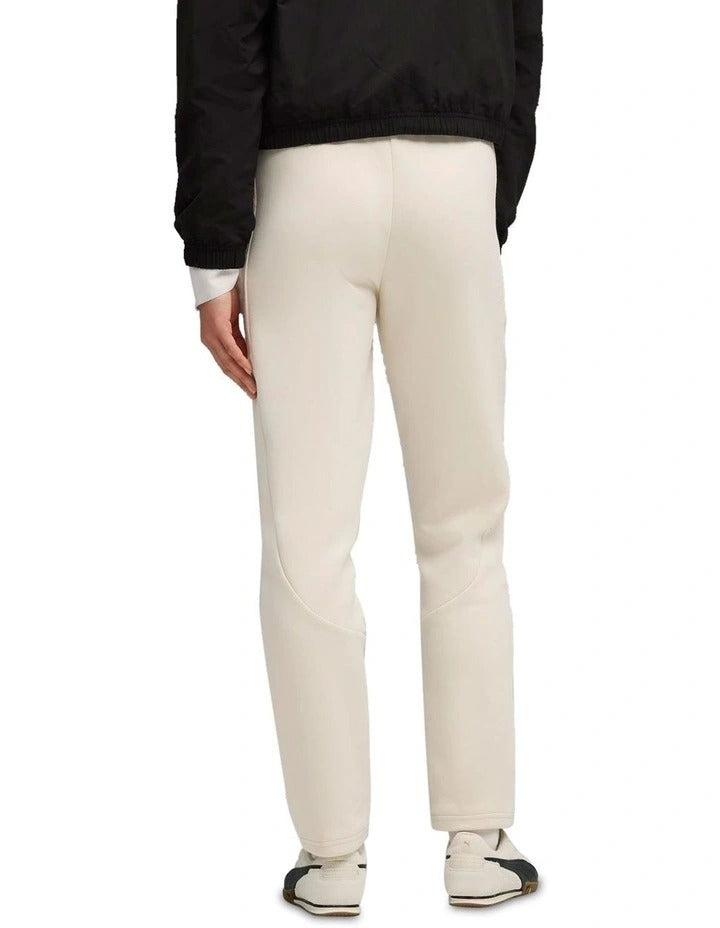 Person wearing beige pants with a white background