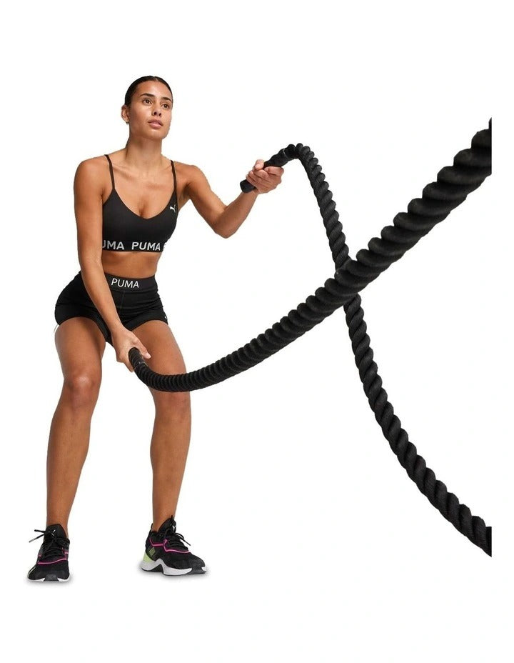 Black Puma sports bra on a model against a white background