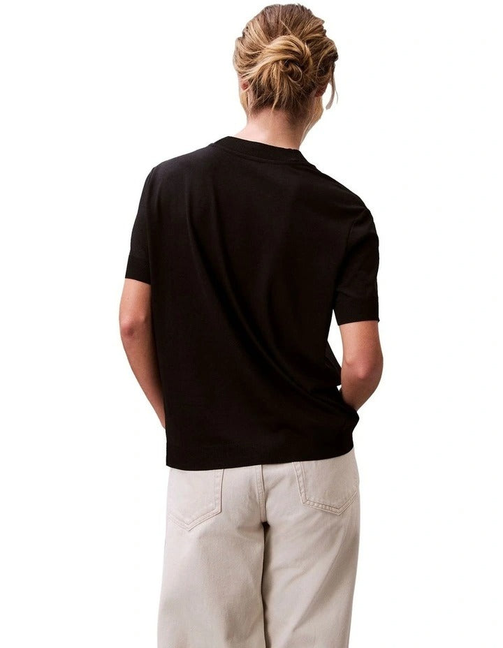 Calvin Klein women’s mock neck top in lyocell cotton blend with ribbed trims, classic fit, and signature logo.