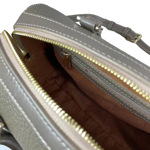 Beige genuine leather barrel shoulder bag with adjustable strap, minimalist design, and premium handcrafted finish.