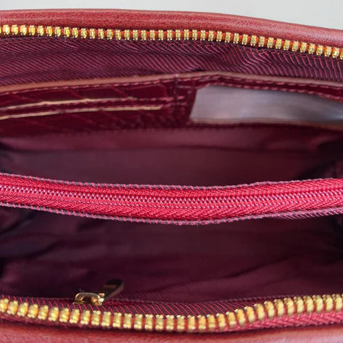 Elegant dark red genuine leather clutch bag with shoulder strap and crossbody design — LeatherLuxe premium women’s handbag