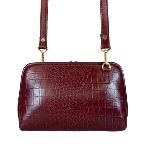 Elegant dark red genuine leather clutch bag with shoulder strap and crossbody design — LeatherLuxe premium women’s handbag