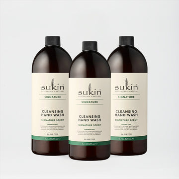 Three bottles of Sukin cleansing hand wash on a light gray background