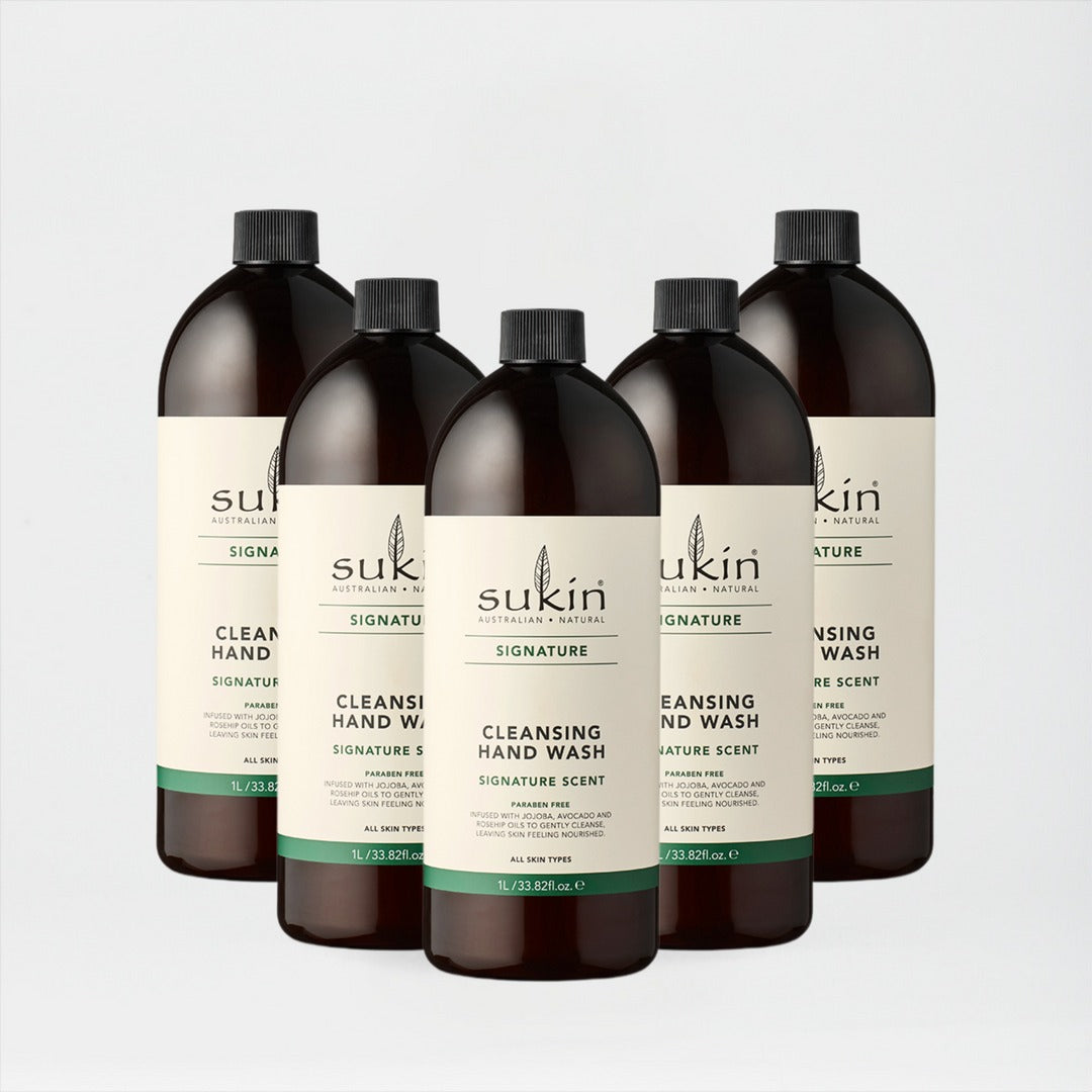 Five bottles of Sukin hand wash on a light gray background