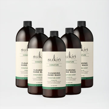 Five bottles of Sukin hand wash on a light gray background