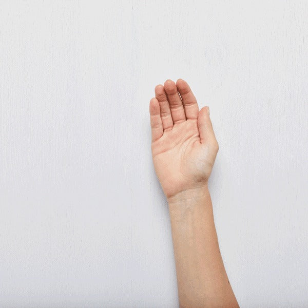 Hand raised on a plain white background