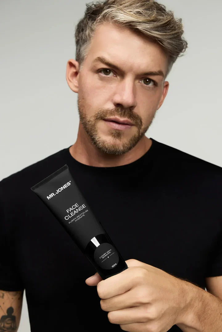 Virtue men’s skincare set with cleanser, exfoliator, moisturizer, face mask, and serum in sleek black packaging displayed with male models