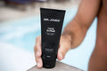 Virtue men’s skincare set with cleanser, exfoliator, moisturizer, face mask, and serum in sleek black packaging displayed with male models