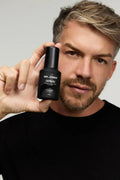 Virtue men’s skincare set with cleanser, exfoliator, moisturizer, face mask, and serum in sleek black packaging displayed with male models