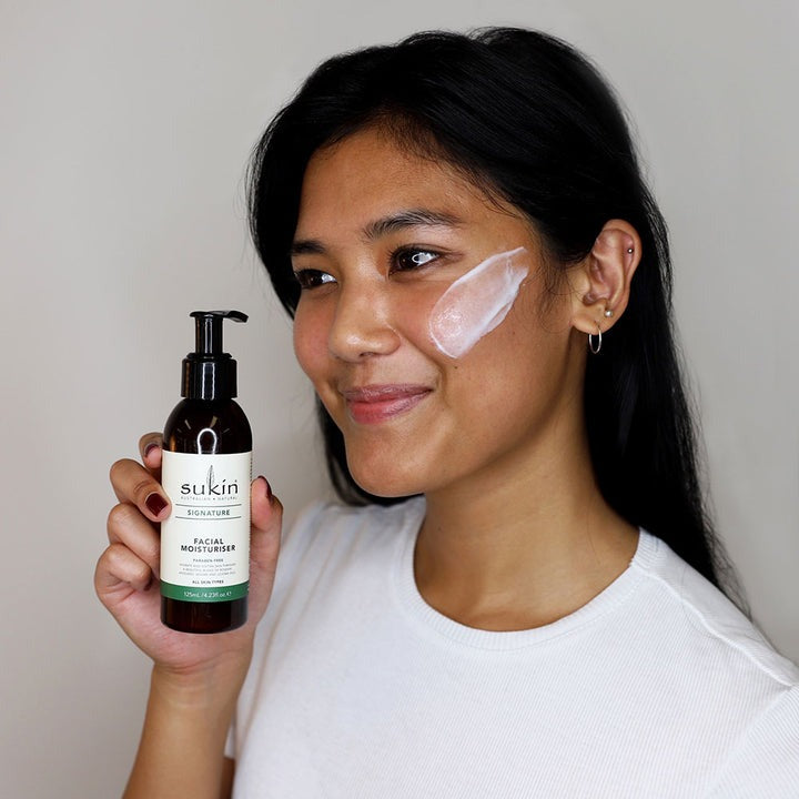 Sukin facial moisturizer bottle on a light gray background