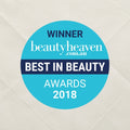 Winner badge for Best in Beauty Awards 2018 from beautyheaven.com.au on a textured beige background