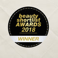 Badge for 'Beauty Shortlist Awards 2018 Winner' on a textured beige background