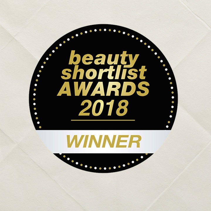 Badge for 'Beauty Shortlist Awards 2018 Winner' on a textured beige background