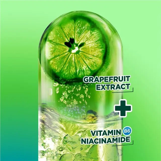 Grapefruit extract with vitamin B6 niacinamide on a green background