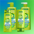 Garnier Fructis shampoo and conditioner bottles on a gradient blue to green background