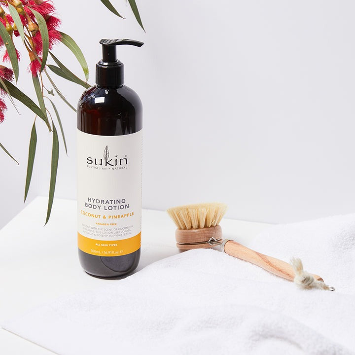 Sukin hydrating body lotion bottle on a light gray background