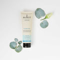 Sukin hair mask tube with eucalyptus leaves on a white background