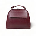 Elegant dark red genuine leather women’s satchel handbag with structured medium design and gold-tone accents — perfect for everyday and office wear.