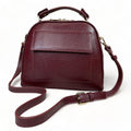 Elegant dark red genuine leather women’s satchel handbag with structured medium design and gold-tone accents — perfect for everyday and office wear.