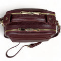 Elegant dark red genuine leather women’s satchel handbag with structured medium design and gold-tone accents — perfect for everyday and office wear.