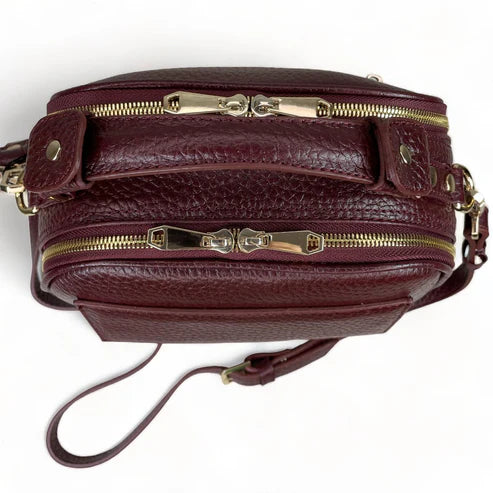 Elegant dark red genuine leather women’s satchel handbag with structured medium design and gold-tone accents — perfect for everyday and office wear.