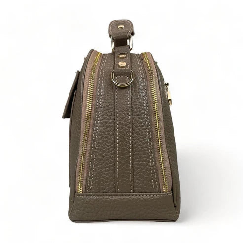 Beige leather women's handbag with shoulder strap — elegant satchel for everyday and formal occasions.