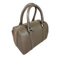 Beige genuine leather barrel shoulder bag with adjustable strap, minimalist design, and premium handcrafted finish.