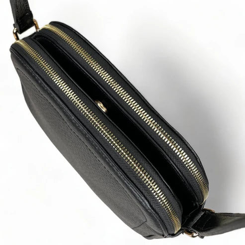 Premium black leather crossbody shoulder bag with adjustable strap, sleek minimalist design, and high-quality stitching for everyday use.