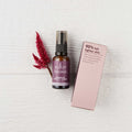 Sukin Intensive Firming Serum with packaging on a textured white surface