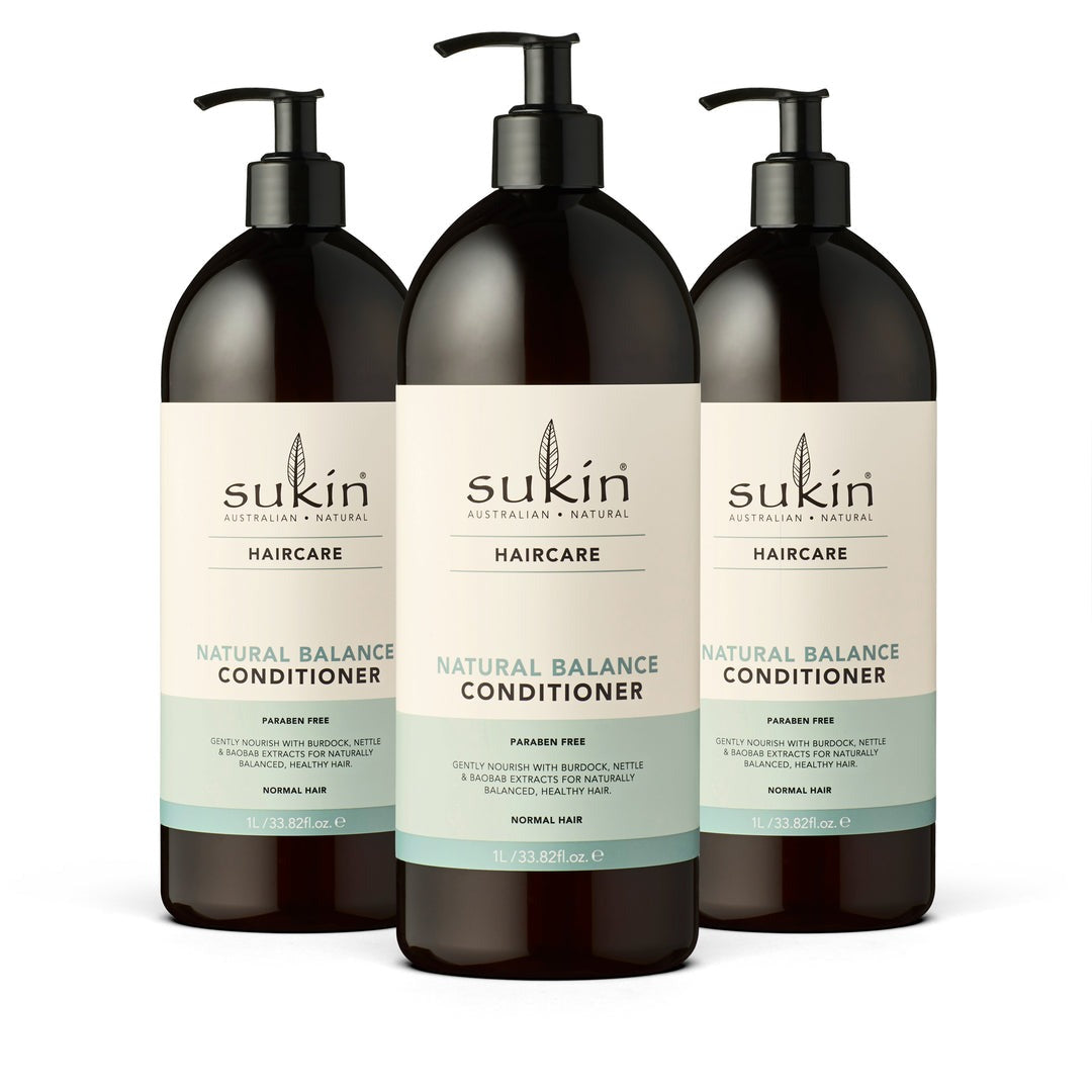 Three bottles of Sukin Natural Balance Conditioner on a white background