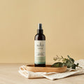 Sukin hair care product on a wooden tray with a beige background