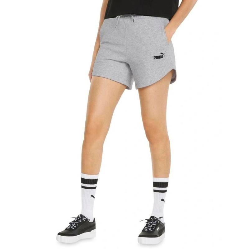 Person wearing gray Puma shorts on a white background