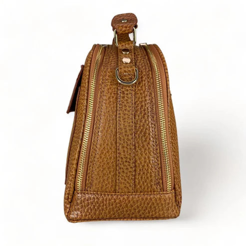 Premium leather women's handbag in satchel and shoulder bag style, featuring elegant stitching, durable handles, and a classic design for everyday and formal use.