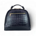 LeatherLuxe black leather women’s handbag – elegant crocodile-textured satchel bag with premium glossy finish and gold hardware.