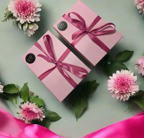 Lavvish Relax self-care gift box with skincare products, bath salts, donut soap, face mask brush, and rose decor displayed on tropical background