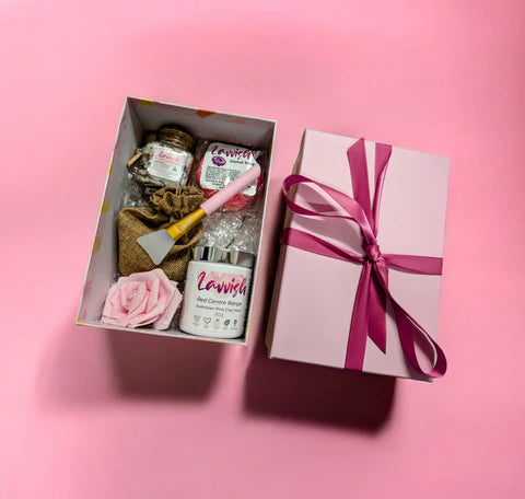 Lavvish Relax self-care gift box with skincare products, bath salts, donut soap, face mask brush, and rose decor displayed on tropical background
