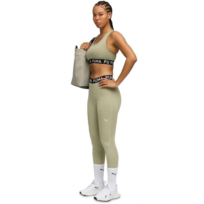 Woman wearing Puma athletic wear on a white background