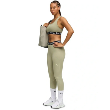 Woman wearing Puma athletic wear on a white background