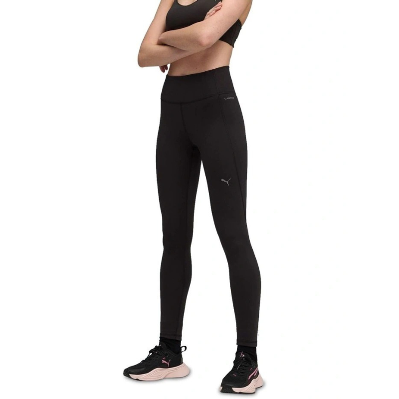 Person wearing black athletic leggings with a small logo on a white background