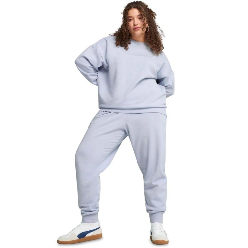 Person wearing a light gray sweatshirt and pants set on a white background