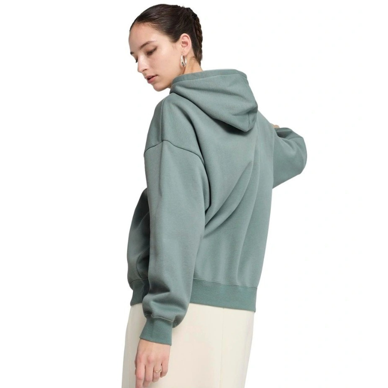 Person wearing a green hoodie on a white background