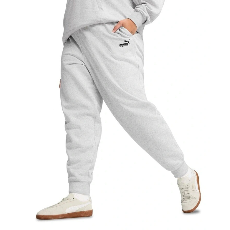 Person wearing gray Puma sweatpants on a white background