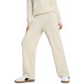 Person wearing a beige tracksuit with white sneakers on a white background