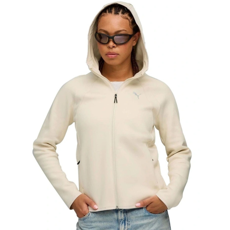 Person wearing a beige hoodie and sunglasses on a white background